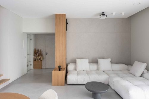 Deze woning in een buitenwijk van Vilnius is ingericht met een natuur geïnspireerd interieur met betonstuc, hout en warme texturen