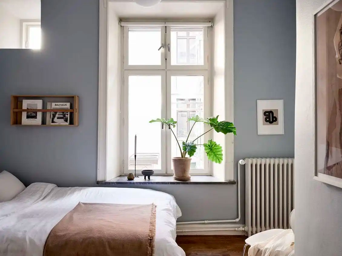 Leuke frisse slaapkamer met ijsblauwe muren.